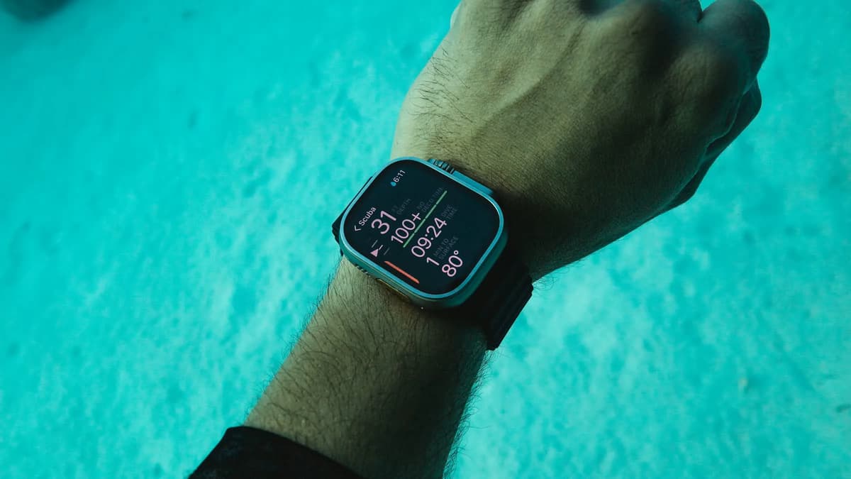 Freediving computer on a wrist displaying depth and dive time underwater